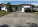Charming single-story home with a well-maintained lawn, mature landscaping, and a long driveway at 102 Center Sw St, Winter Haven, FL 33880