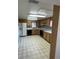 A well-lit kitchen with wooden cabinets, laminate countertops, and black appliances at 102 Center Sw St, Winter Haven, FL 33880