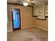 A living room features carpeted floors, built-in shelves, and access to the kitchen at 102 Center Sw St, Winter Haven, FL 33880