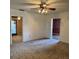 Spacious living room featuring a ceiling fan and doorways leading to other rooms at 102 Center Sw St, Winter Haven, FL 33880