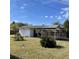Backyard shed with adjacent covered parking featuring mature landscaping at 102 Center Sw St, Winter Haven, FL 33880