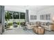 Stylish living room showcasing contemporary furniture, an area rug, and large sliding glass doors leading to a patio at 163 River Front Way, Edgewater, FL 32141