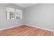 Bedroom with wood floors, a large window that lets in natural light, and neutral colored walls at 211 W Valencia St, Lakeland, FL 33805