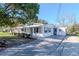 A bright home showing a side view with long drive-way at 211 W Valencia St, Lakeland, FL 33805