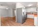 Eat-in kitchen features stainless steel appliances and white cabinets, with an adjacent living space at 211 W Valencia St, Lakeland, FL 33805