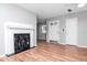 Bright living room showcasing a modern fireplace, wood-look floors, and a fan at 211 W Valencia St, Lakeland, FL 33805