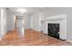 Living room featuring wood floors and fireplace, with views to another room beyond at 211 W Valencia St, Lakeland, FL 33805