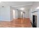 Spacious living room with wood-look flooring, neutral walls, and a decorative fireplace at 211 W Valencia St, Lakeland, FL 33805