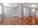 Open living room features wood floors, a ceiling fan, and neutral paint, creating a bright and airy space at 211 W Valencia St, Lakeland, FL 33805