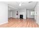 Bright and airy living room featuring a fireplace, ceiling fans, and wood-look floors at 211 W Valencia St, Lakeland, FL 33805