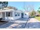 Exterior view of a cozy home, highlighting the driveway and side entrance at 211 W Valencia St, Lakeland, FL 33805