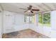 Enclosed sunroom with windows, a ceiling fan, and access to the outdoor space at 211 W Valencia St, Lakeland, FL 33805