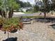 Inviting front yard with flower planter, stone walkway and manicured gravel landscaping at 3017 Wekiva Rd, Tavares, FL 32778