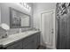 Bathroom with a large framed mirror above the sink and gray cabinets at 7641 Sw 185Th Cir, Dunnellon, FL 34432