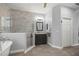 Bathroom featuring marble tiled shower, marble topped vanity, and clawfoot tub at 7641 Sw 185Th Cir, Dunnellon, FL 34432