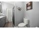 Gray bathroom featuring a shower, toilet, and eye-shaped art at 7641 Sw 185Th Cir, Dunnellon, FL 34432