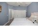 Bedroom featuring a plush bed, multiple closets, and light blue walls at 7641 Sw 185Th Cir, Dunnellon, FL 34432