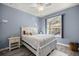 Bedroom with large window, ceiling fan and a cozy bed at 7641 Sw 185Th Cir, Dunnellon, FL 34432