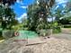 A serene, crystal-clear community pool with lush greenery and a safety fence at 7641 Sw 185Th Cir, Dunnellon, FL 34432