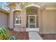 Charming front entrance featuring a screened in porch, walkway, and well maintained landscaping at 7641 Sw 185Th Cir, Dunnellon, FL 34432
