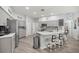 Modern kitchen with an island, stainless steel appliances, granite countertops, and bar stool seating at 7641 Sw 185Th Cir, Dunnellon, FL 34432