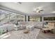Bright living area featuring a white sectional, large windows, and a view of the outdoor pool at 7641 Sw 185Th Cir, Dunnellon, FL 34432