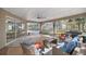Covered patio with outdoor seating, a grill, and view of screened in pool area at 7641 Sw 185Th Cir, Dunnellon, FL 34432