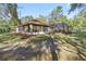Home exterior featuring a large screened lanai and well-maintained landscaping at 7641 Sw 185Th Cir, Dunnellon, FL 34432