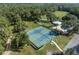Aerial view of the tennis courts and community pool area with lush trees and parking at 7641 Sw 185Th Cir, Dunnellon, FL 34432
