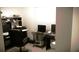 Functional office with two desks, multiple monitors, and a rolling office chair at 580 Tree Shore Dr, Orlando, FL 32825