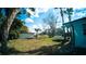 Wide backyard featuring mature trees, an additional shed, and a lush green lawn at 1401 Josephine St, Lakeland, FL 33815