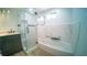 Stylish bathroom with a tiled tub and shower, new vanity, and sleek fixtures at 1401 Josephine St, Lakeland, FL 33815