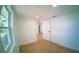 Clean bedroom with wood-look floors, a window, and a doorway to other rooms in the home at 1401 Josephine St, Lakeland, FL 33815