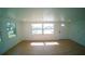 Bright living room featuring new wood flooring, white walls and ample natural light from large windows at 1401 Josephine St, Lakeland, FL 33815