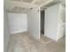 Bedroom featuring tile flooring, access to multiple rooms, and awaiting updates at 301 Bassedena N Cir, Lakeland, FL 33805