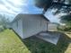 Exterior of garage with a concrete pad, set against a backdrop of a well-maintained lawn at 301 Bassedena N Cir, Lakeland, FL 33805