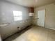 Kitchen area with a window, awaiting modern updates and featuring tile flooring at 301 Bassedena N Cir, Lakeland, FL 33805