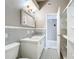 Bathroom featuring a sink, toilet, and storage shelving with a tiled floor at 305 Bearcreek Dr, Bartow, FL 33830