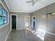 Spacious bedroom featuring tile floors, a ceiling fan, and an ensuite bathroom and closet at 305 Bearcreek Dr, Bartow, FL 33830