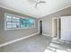 Bright bedroom with tile floors, a ceiling fan, and a large window letting in natural light at 305 Bearcreek Dr, Bartow, FL 33830