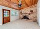 Cozy den with a wood ceiling, a brick fireplace, and natural light at 305 Bearcreek Dr, Bartow, FL 33830