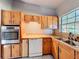 This well-lit kitchen features stainless steel appliances and ample wooden cabinet space at 305 Bearcreek Dr, Bartow, FL 33830