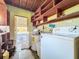 Functional laundry room with washer, dryer and ample shelving at 305 Bearcreek Dr, Bartow, FL 33830