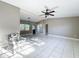 Open living room featuring tiled floors, neutral paint, and a chair for staging at 305 Bearcreek Dr, Bartow, FL 33830