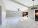 Bright living room with tile flooring, a decorative ceiling fan, and ample natural light at 305 Bearcreek Dr, Bartow, FL 33830