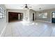 Open living room featuring tiled floors, neutral paint, and views into the den at 305 Bearcreek Dr, Bartow, FL 33830