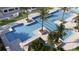 An aerial view of the community pool area, featuring palm trees, a splashpad, and ample seating at 4429 Sw 84Th Street Rd, Ocala, FL 34476