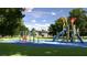 A fun playground area with swings and slides on a soft blue surface, surrounded by green lawns at 4429 Sw 84Th Street Rd, Ocala, FL 34476