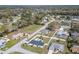 This aerial view showcases a residential neighborhood with mature trees, lawns, and several homes with swimming pools at 17 Se 61St Ct, Ocala, FL 34472