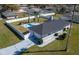 Aerial view of property showing backyard pool, white fence, and ample green space at 17 Se 61St Ct, Ocala, FL 34472